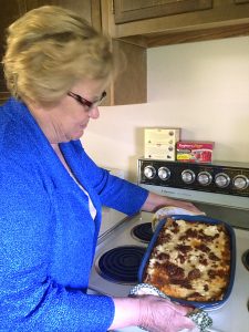Lois Roggow witnessed the miracle of over 40 people receiving large servings of lasagna (and even seconds and leftovers) from a single 9x13 pan. Photo by Christina Obsborn.