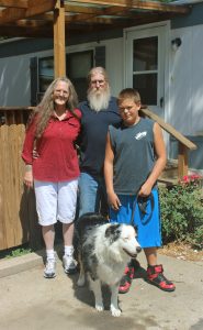 Jeanne and John Artz and their grandson, Gage, pictured with their dog, Spot, were able to purchase a new mobile home after theirs burned. Photo by Vanessa Schaecher.