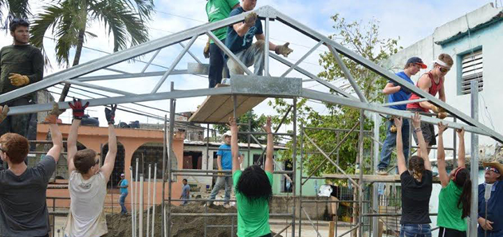 Students from Mile High, Campion, Vista Ridge academies and public and home schools work together erecting the steel frame for a church building. Photo courtesy Clint Watson.