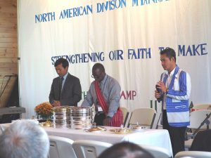 Elder Gil Webb, vice president of administration for the Mid-America Union Conference, officiates during a communion service at the 2017 NAD Myanmar Adventist Convention held in Minnesota.