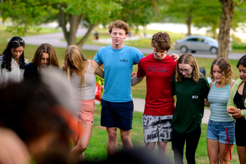 Photo of students in a prayer circle