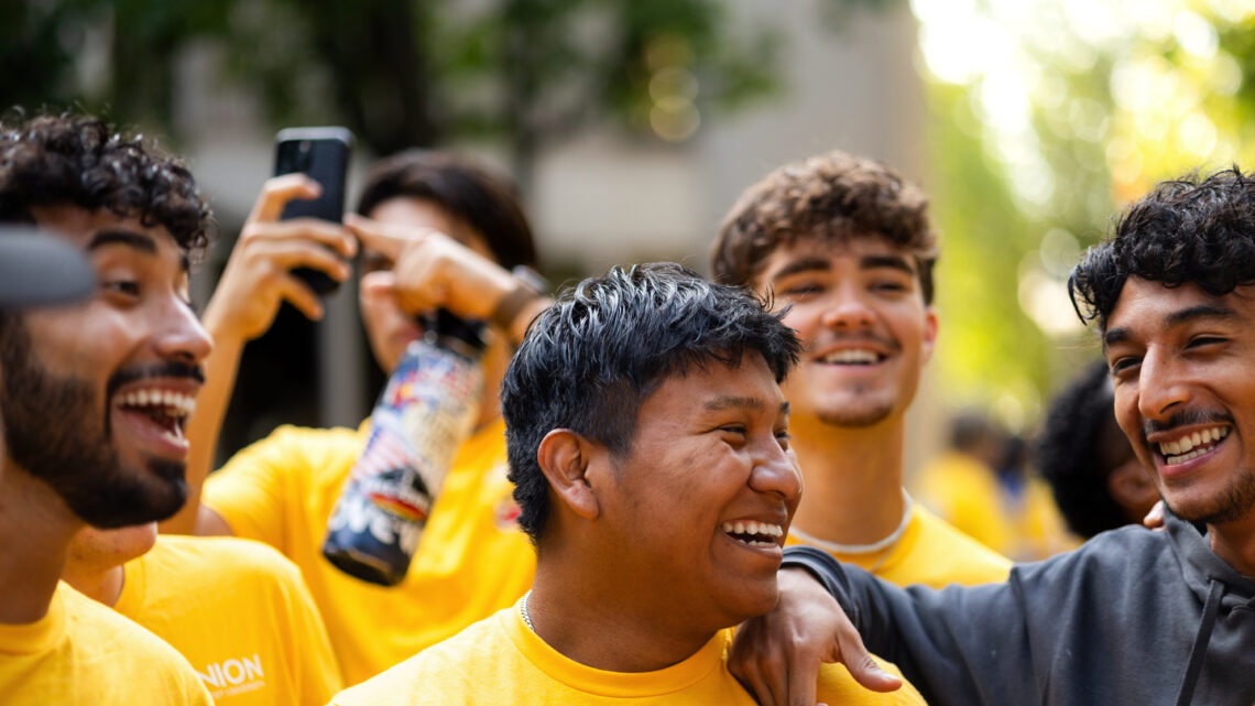 Photo of students laughing together.