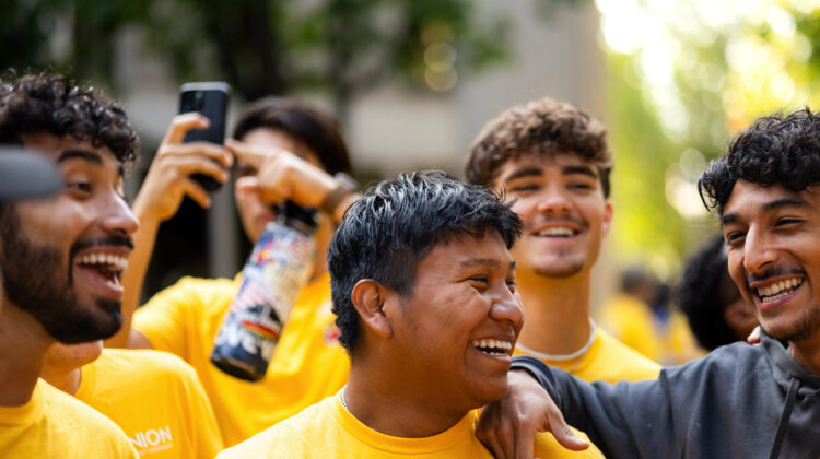 Photo of students laughing together.