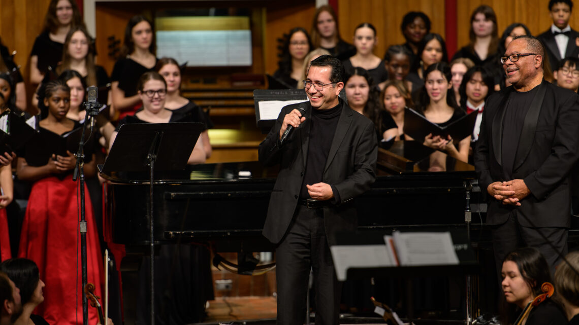 Photo of Dr. David Nino in front of the festival choir