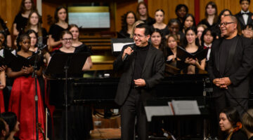 Photo of Dr. David Nino in front of the festival choir