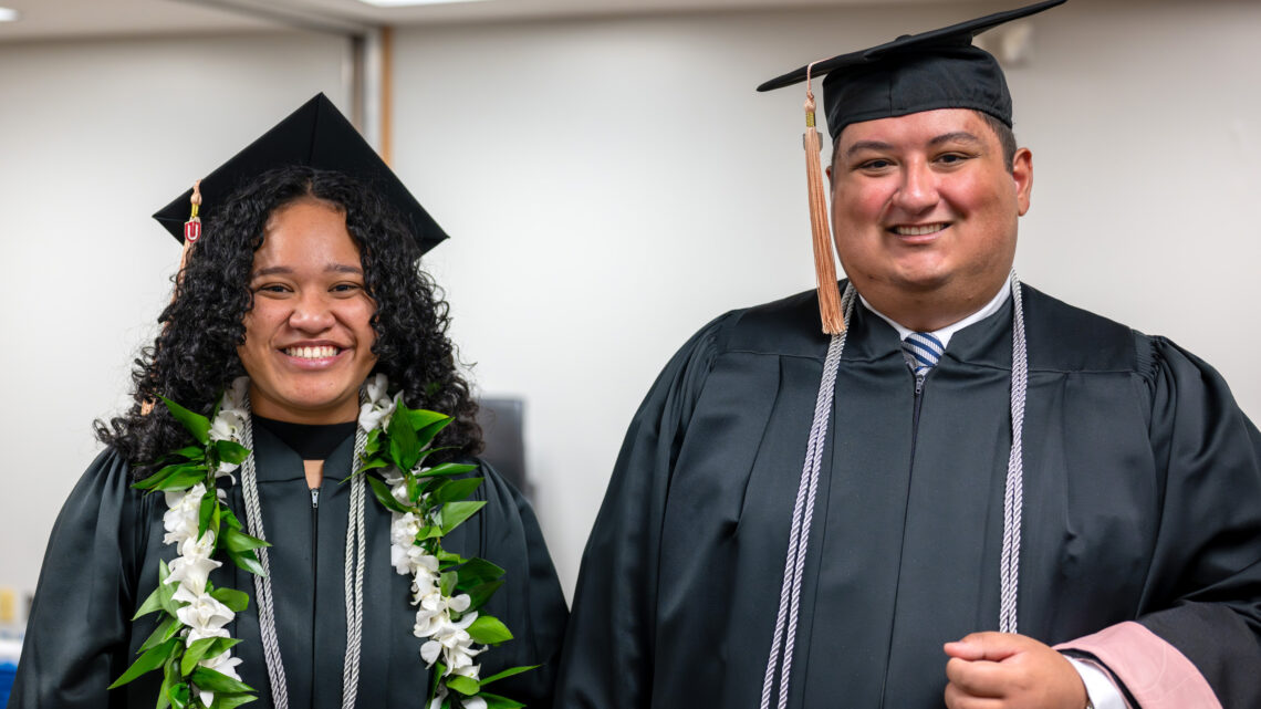 Photo of Ingrid Papalii and Joshua Reyes-Meiring in graduation regalia